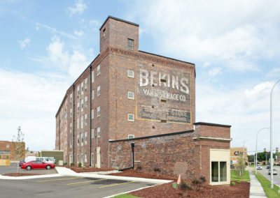 This is a front view of the Hons 5-story brick apartment building.