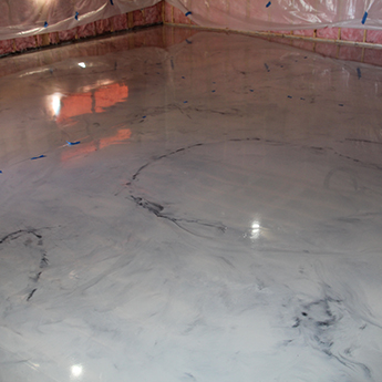 A close up view of a grey, marbled epoxy floor